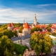 Scenic Tallinn summer cityscape with Saint Olav's church and old town walls and towers at sunset, Estonia