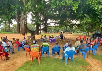 Community gathered under a tree