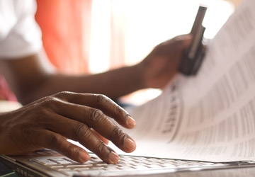 Hands typing on a keyboard