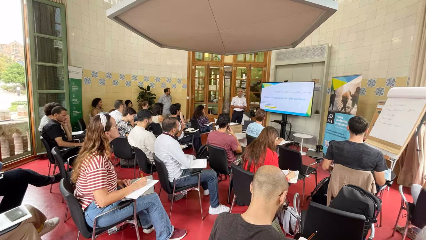 A forestry leadership workshop in progress, showing a presenter and an audience of students and professionals.