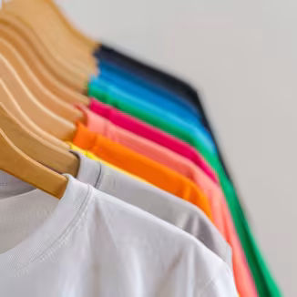 colourful t-shirts in hangers