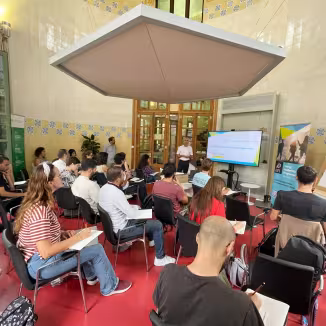 A forestry leadership workshop in progress, showing a presenter and an audience of students and professionals.