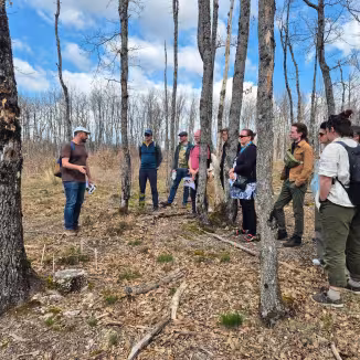 group of people on a field visit to a forest test site 