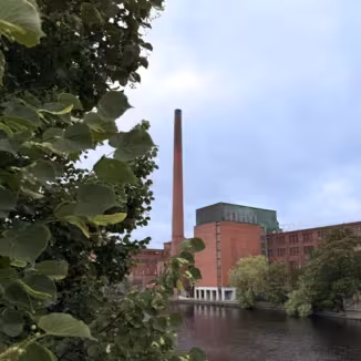 brick industrial building along along a dark river