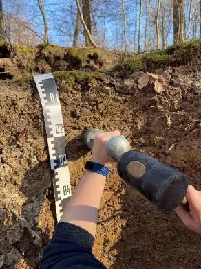 Photo shows sampling bulk density with core.