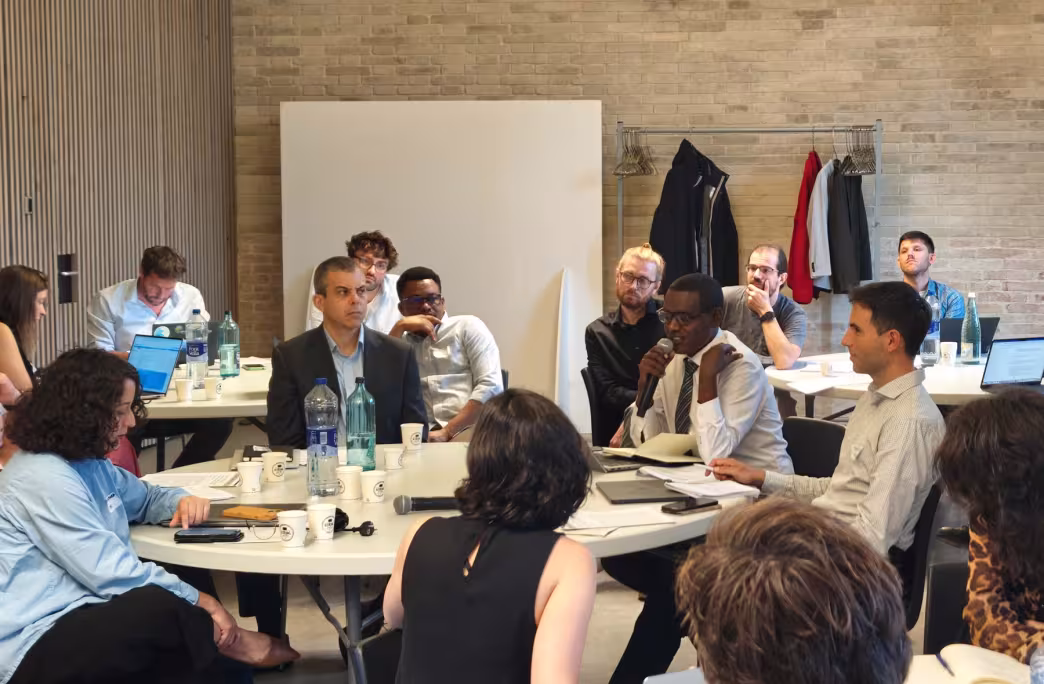 A participant speaking during a roundtable discussion at the technical workshop in Barcelona.